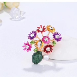 Retro colorful daisy flower brooch with bird detail and pearl pendant on white background