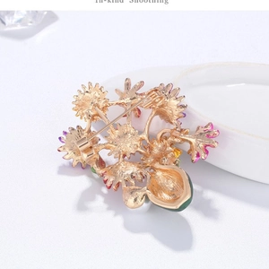 Vintage gold daisy flower brooch with purple enamel petals and green water-drop pendant