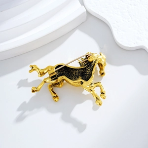 Vintage gold-plated galloping horse brooch with detailed antique finish and safety pin clasp