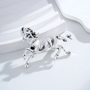 Vintage silver stallion horse brooch in galloping pose with textured metallic finish