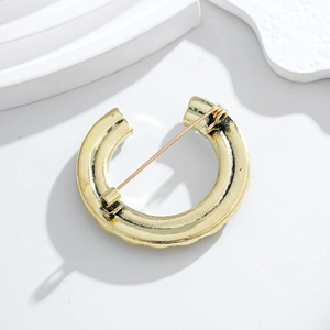 Vintage golden C-shaped pearl brooch with hammered texture and secure back pin
