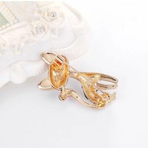 Back view of a gold alloy cat brooch featuring a safety pin clasp and colorful accents