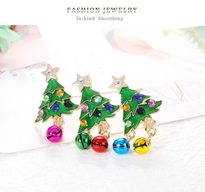 Detailed view of colorful rhinestones and dangling bells on Christmas tree brooch