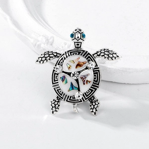 Vintage silver turtle brooch with blue rhinestone eyes and colorful shell inlay