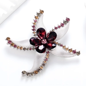 Spilla a forma di stella marina con cristalli rossi e strass colorati su base argento