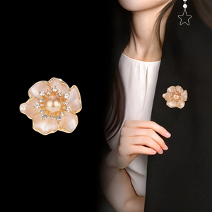 Elegant camellia flower brooch with pearl and crystals on a black blazer jacket