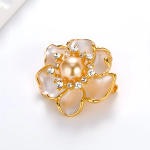 Elegant camellia flower brooch with white petals, pearl center and gold trim