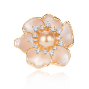 Elegant camellia brooch with shell petals and central gold pearl on a white background