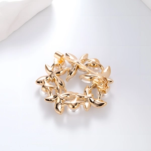 Elegant gold butterfly wreath brooch with pearls and rhinestones on a clean background