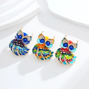 Three colorful handmade owl brooches with enamel finish and sparkling crystal accents