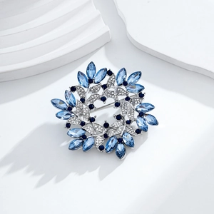 Spilla a corona in cristallo vintage con gemme blu e diamanti su sfondo minimalista