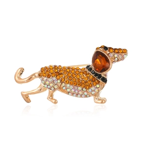 Golden dachshund dog brooch featuring colorful rhinestones and amber crystal stone inlay