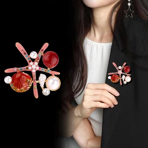 Marine style brooch featuring a pink starfish, red shell, and colorful crystal rhinestones