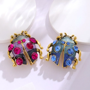 Elegant ladybug brooches with colorful enamel and sparkling crystals in purple and teal blue