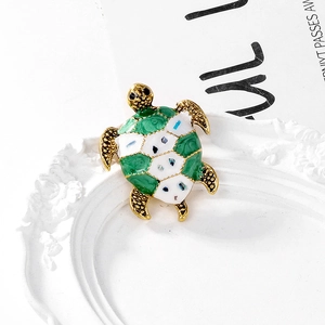 Retro sea turtle brooch with green enamel and mother of pearl inlay on gold metal base