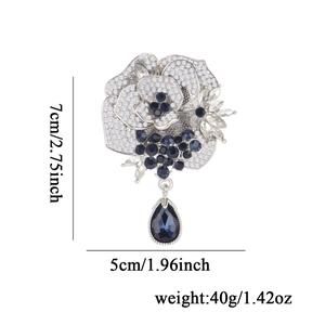 Sparkling camellia flower brooch with blue crystal drop pendant and silver plated rhinestones