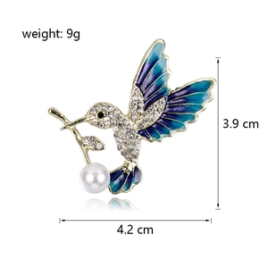 Elegant hummingbird enamel brooch with blue crystals and a white pearl drop pendant
