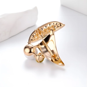 Exquisite gold sailboat brooch featuring elegant white pearls and sparkling rhinestones