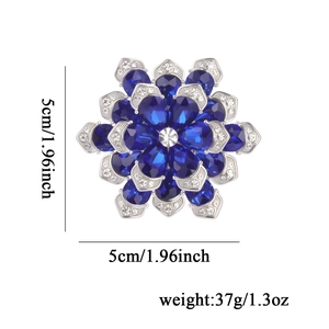 Elegant silver-tone snowflake brooch with navy blue crystals, measuring 5cm by 5cm