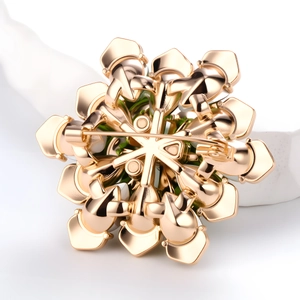 Elegant gold flower brooch showing detailed back structure and secure pin closure