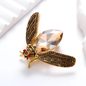 Vintage cicada brooch with champagne crystal and brown rhinestones on a gold base