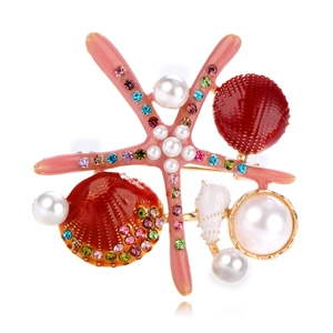 Close-up of starfish brooch with colorful rhinestones, enamel shells, and white pearls