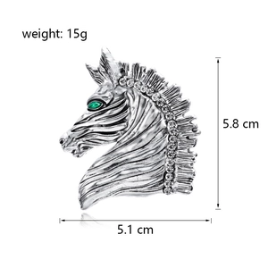 Vintage horse head brooch in silver alloy with green gem eye and white rhinestones