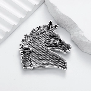Silver vintage horse head brooch with rhinestone accents shown from a detailed back view
