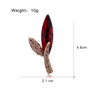 Elegant leaf brooch with large red zircon and pavé crystals in rose gold finish