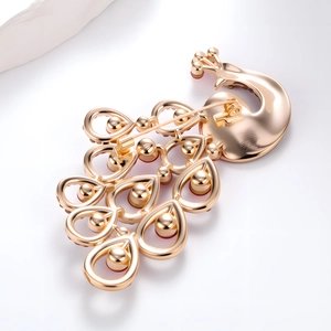 Back view of vintage peacock brooch in gold-plated alloy with pin clasp mechanism