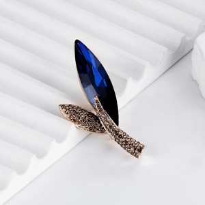 Elegant rose gold leaf brooch with deep blue crystal and sparkling rhinestones