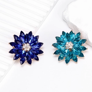Luxury 3D lotus flower brooches with navy and teal gems on gold-toned setting