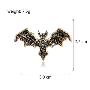 Vintage crystal bat brooch with purple rhinestones and grey teardrop stone on white base
