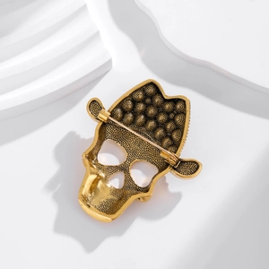 Detail view of the vintage gold skull brooch back with secure pin and textured finish