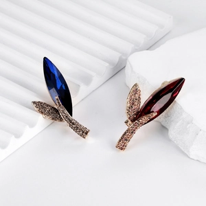 Elegant leaf-shaped crystal brooch set with deep blue and red rhinestones in rose gold