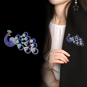 Exquisite peacock brooch with blue rhinestones on a blazer, showing front and worn views