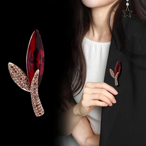 Elegant red marquise crystal leaf brooch with micro-pave diamonds on black suit