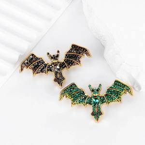 Vintage crystal bat brooches in purple and green rhinestones on gold metal bases
