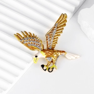 Golden eagle brooch with spreading wings and glitter accents on white background