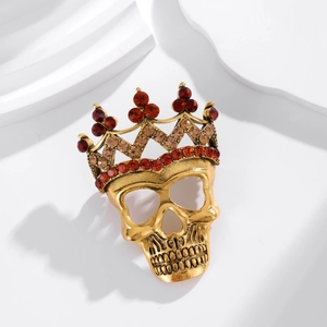 Gothic skull brooch with rhinestone crown on minimalist white background with shadows