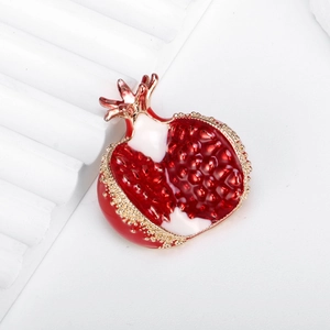 Exquisite pomegranate brooch with red enamel and gold-plated details on white background