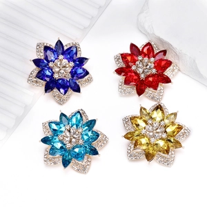 Elegant floral crystal brooches in four colors set on a white minimalist background