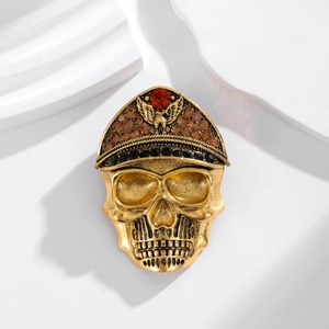 Vintage gold skull brooch with eagle military cap and colorful rhinestones on white base