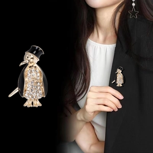 Cute penguin brooch with white rhinestones and black enamel on a gold metal base