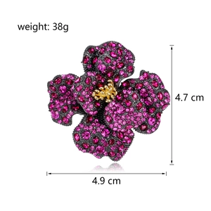 Luxury rose brooch with purple rhinestones and gold details on white background