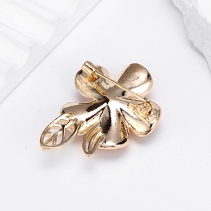 Elegant gold flower brooch with crystal petals and secure safety pin back view
