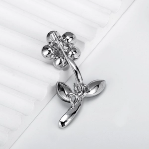 Elegant silver flower brooch with rhinestones featuring a sturdy back pin closure