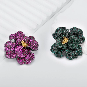 Vintage luxury rose brooches with rhinestones and gold flower buds on stone props