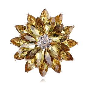 Macro detail of luxury crystal snowflake brooch with yellow marquise rhinestones