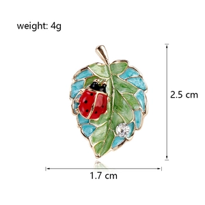 Exquisite enamel ladybug on leaf brooch with dimensions 2.5cm x 1.7cm on white background